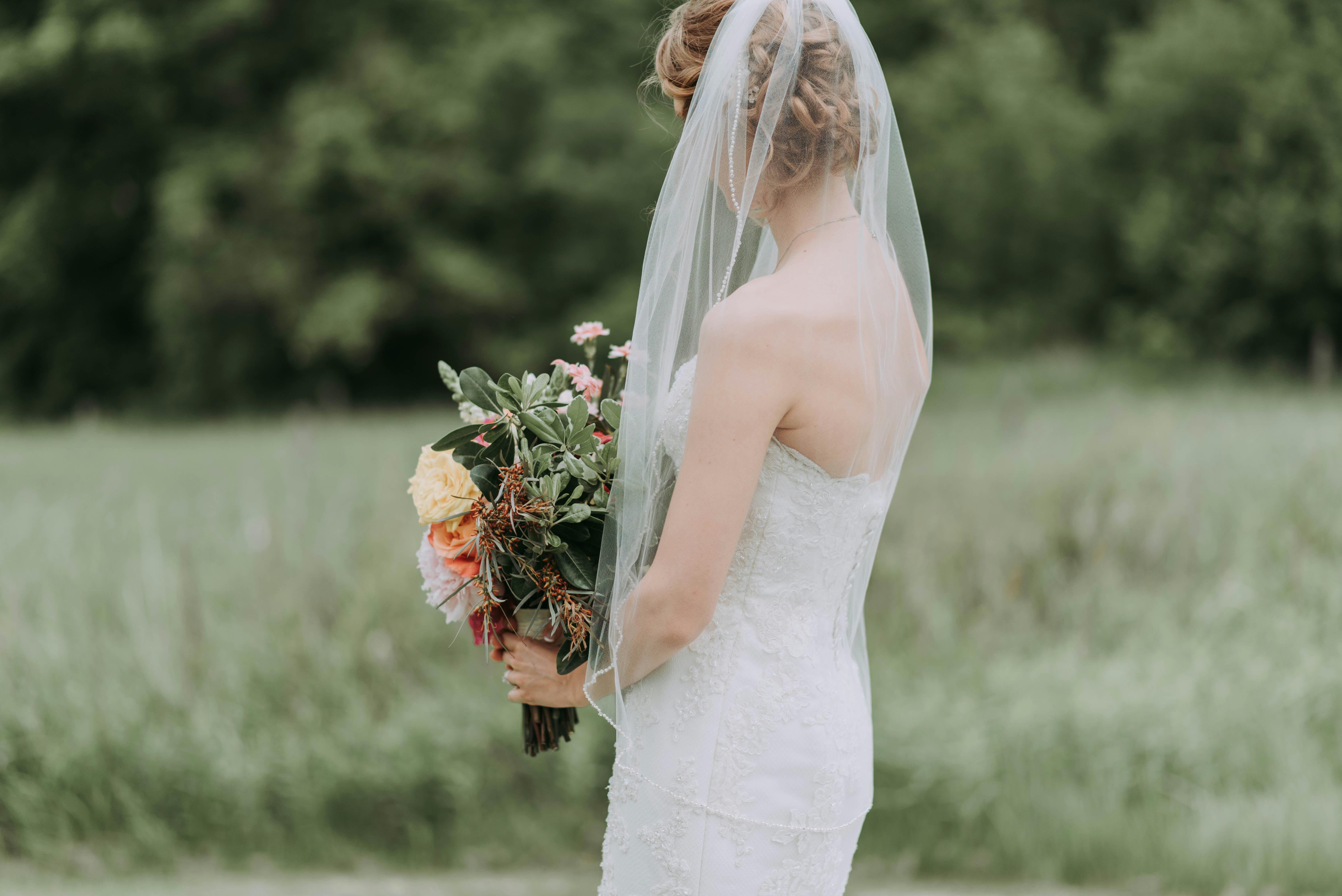 woman holding bouquet of flower